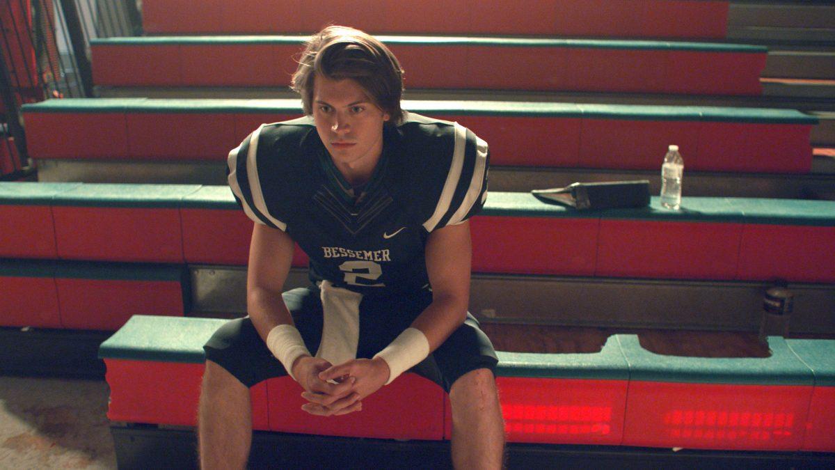 Star high school quarterback Zach Truett (Tanner Stine) calms his nerves before taking the field in “Run the Race.” (RTR Movie Holdings, LLC)