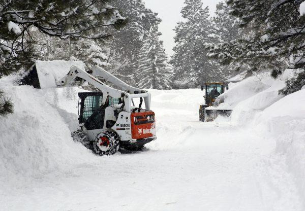 Snow-throwers and front-end loaders are move snow in the Durango West II Subdivision west of Durango, Colo., on Feb. 22, 2019. (Jerry McBride/The Durango Herald via AP)