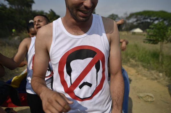 A man wears an anti-Maduro t-shirt as he walks to the place where "Venezuela Aid Live" concert will be held at Tienditas International Bridge in Cucuta, Colombia, on Feb. 22, 2019. (Luis Robayo/AFP/Getty Images)