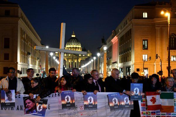 Members of Ending Clergy Abuse (ECA), hold a protest gathering on Feb. 21, 2019, by the Castel Sant'Angelo in Rome, with the Vatican's St. Peter's Basilica in background. (ALBERTO PIZZOLI/AFP/Getty Images)