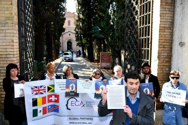 Spanish victim of sexual abuse, Miguel Hurtado (Front R), Jamaican victim of sexual abuse, Denise Buchanan (Rear 2ndL) and other members of Ending Clergy Abuse (ECA), stage a protest gathering on Feb. 22, 2019, outside the Benedictine monastery of Sant' Anselmo in Rome. (ALBERTO PIZZOLI/AFP/Getty Images)