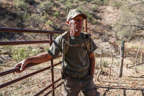 Arizona Border Recon's Tim Foley stands at the U.S.–Mexico border, where a gate gives way to a four-strand barbed wire fence, south of Arivaca, Ariz., on Dec. 8, 2018. (Charlotte Cuthbertson/The Epoch Times)