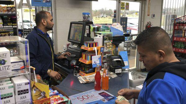 Jee Patel checks out a customer at the KC Mart in Simpsonville, S.C., on Feb. 19, 2019. The store sold the only Mega Millions ticket to win the $1.5 billion jackpot in October 2018. The ticket has not been claimed. (Jeffrey Collins/AP)