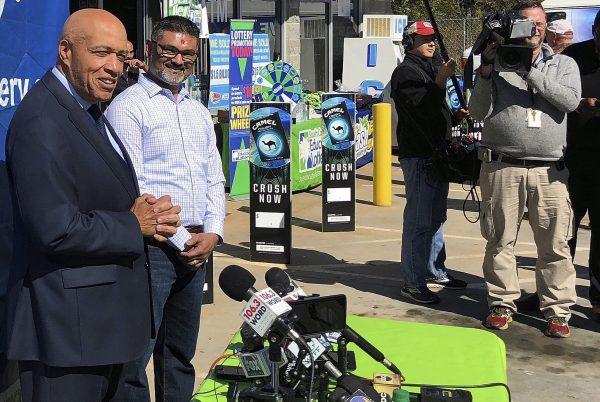 In this photo taken on Oct. 24, 2018, South Carolina Education Lottery Chief Operating Officer Tony Cooper, left, and KC Mart owner CJ Patel, right, speaks to reporters about the winning ticket sold at the Simpsonville, S.C., store. (Jeffrey Collins/AP)