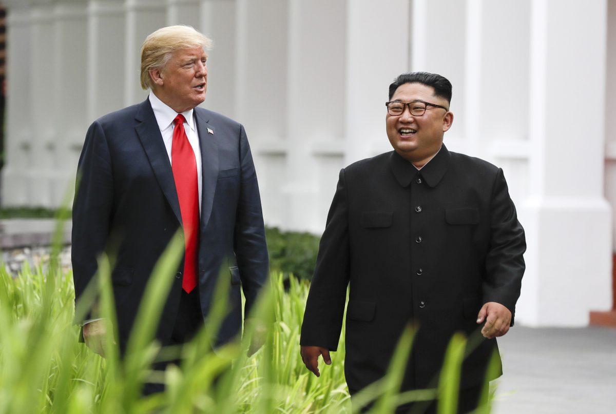 President Donald Trump, left, and North Korea leader Kim Jong Un walk from their lunch at the Capella resort on Sentosa Island in Singapore. June 12, 2018 (AP Photo/Evan Vucci)