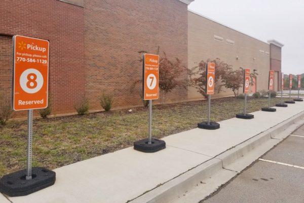Parking stall signs for Walmart online grocery pickup in Cumming, Ga. on Nov. 5, 2018. (Nandita Bose/Reuters)