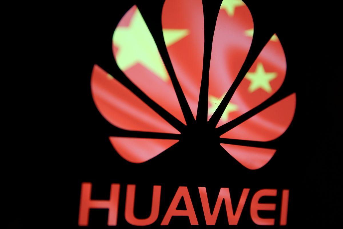 A Huawei logo is seen in front of the Chinese Communist Party flag in a photo illustration taken on Feb. 12, 2019. (Dado Ruvic/Reuters)