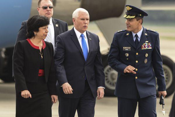 Vice President Mike Pence (C) is welcomed by Colombia's Foreign Affairs Vice Minister Luz Stella Jara (L) and Colombia's Air Force General Luis Carlos Cordoba, upon arrival in Bogota, on Feb. 25, 2019. (Joaquin Sarmiento/AFP/Getty Images)