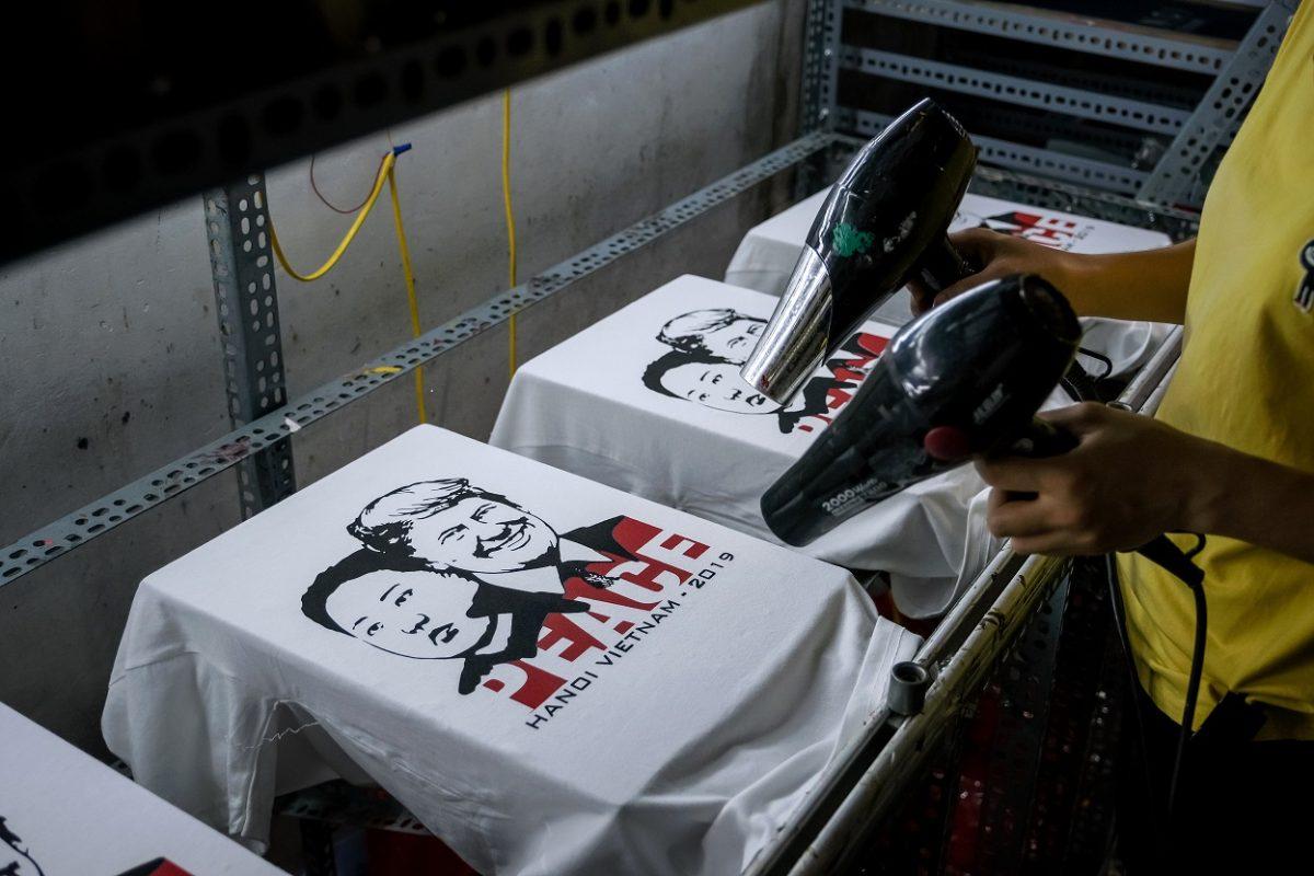 A worker at the T-shirt store of Truong Thanh Duc dry the newly printed T-shirts with the portraits of U.S. President Donald Trump and North Korean leader Kim Jong Un in Hanoi, Vietnam, on Feb. 21, 2019. (Linh Pham/Getty Images)