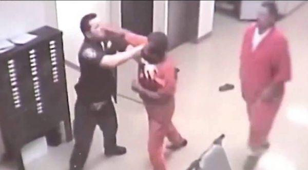 The moment before the other inmate came to the guard's aid. (YouTube / Payne County)