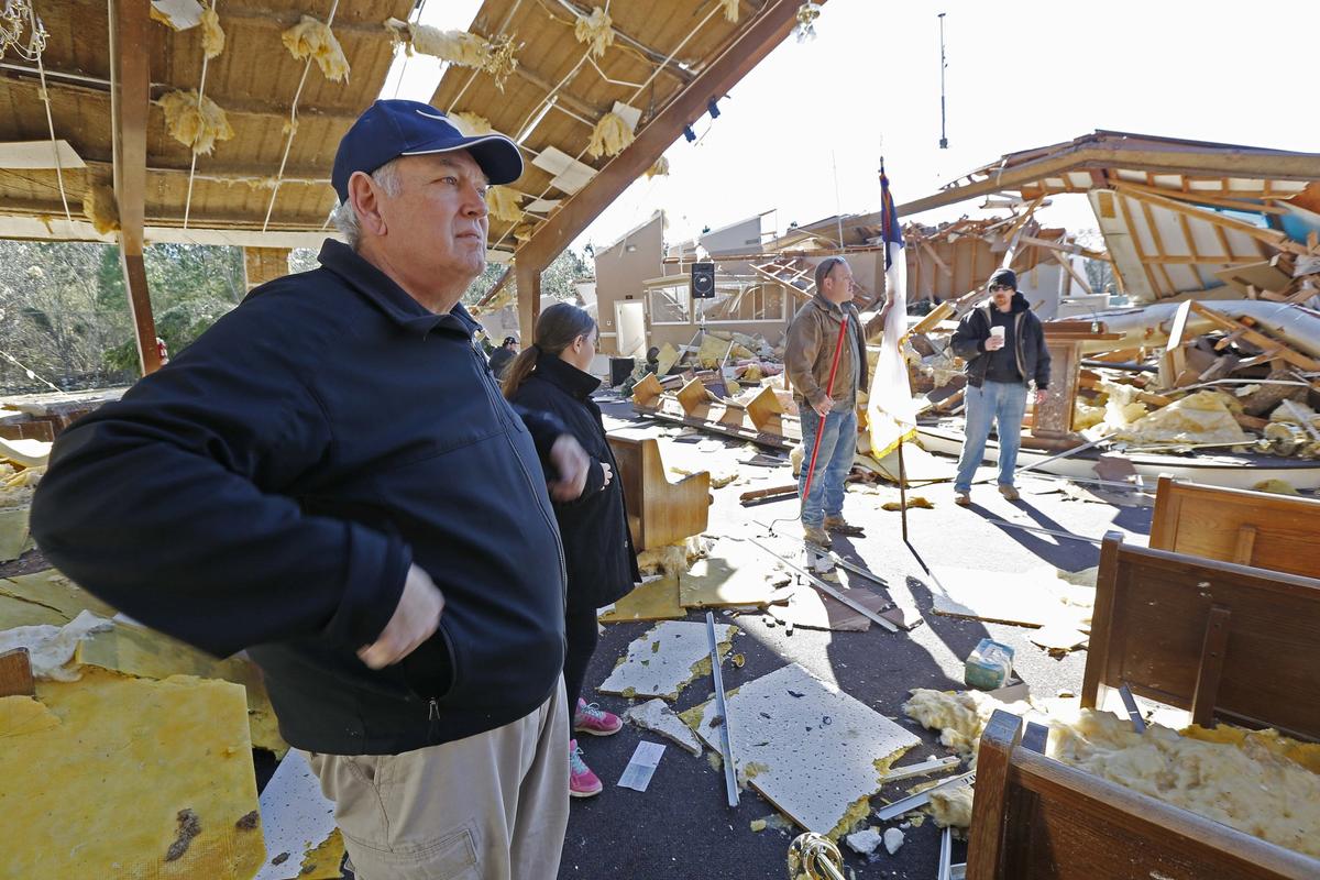 Pastor Steve Blaylock looks over the broken lumber, loose paneling, insulation, and destroyed pews in the First Pentecostal Church in Columbus, Miss., Sunday morning, Feb. 24, 2019 after a Saturday tornado. (Rogelio V. Solis/AP)