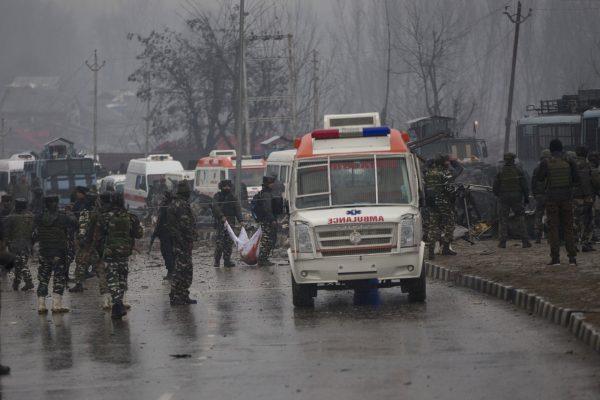 Indian paramilitary soldiers collect body parts of their colleagues at the site of explosion in Letathpora, south of Srinagar, Indian controlled Kashmir, Thursday, Feb. 14, 2019. (AP Photo/ Dar Yasin)