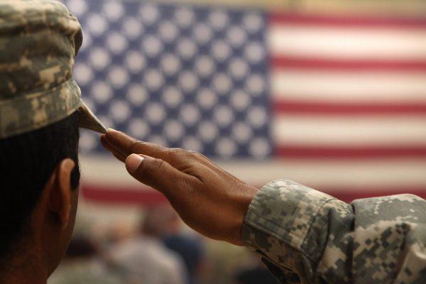 A soldier salutes the flag during a welcome home ceremony for troops arriving from Afghanistan to Fort Carson, Co., on June 15, 2011 (John Moore/Getty Images)
