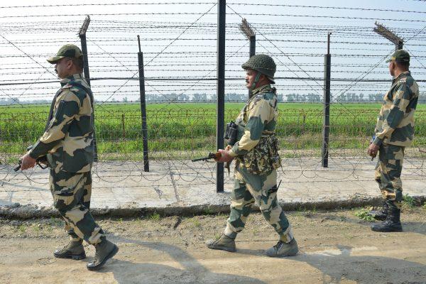 Indian Border Security Force personnel walk along a fence at the India Pakistan border on the outskirts of Amritsar on Feb. 27, 2019. (NARINDER NANU/AFP/Getty Images)