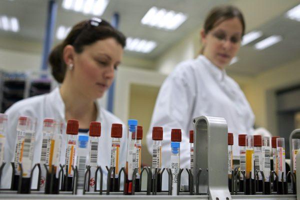 FILE—Laboratory technicians supervising as vials of human blood are processed on an automated testing line at the Maccabi Health Services HMO central laboratory in Nes Tsiona, Israel, on Jan. 22, 2006. (David Silverman/Getty Images)