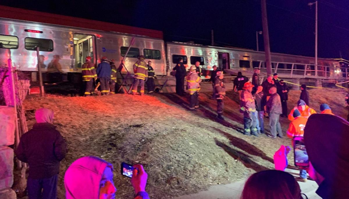 First responders work the scene of a collision involving a Manhattan-bound commuter train and a vehicle in Westbury, N.Y., Tuesday, Feb. 26, 2019. (Howard Schnapp/Newsday via AP)