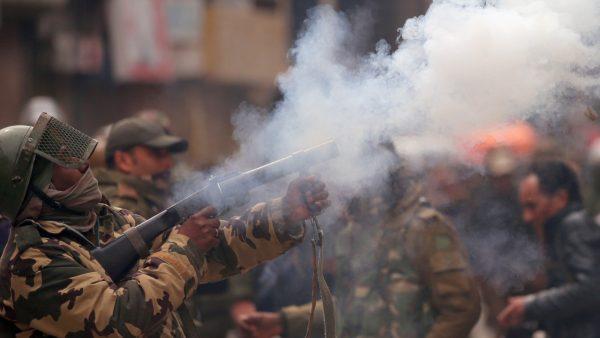 A member of Indian Central Reserve Police Force (CRPF) fires a tear gas shell during a protest by Kashmiri demonstrators after India's National Investigation Agency (NIA) members carried out a raid at the residence of Yasin Malik, Chairman of Jammu Kashmir Liberation Front (JKLF), a separatist party, in Srinagar, on Feb. 26, 2019. (Danish Ismail/Reuters)