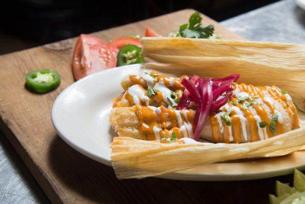 The chipotle chicken tamale, with chipotle mayo on top, and crema fresca. Served with pickled red onion. (Courtesy of @thebronxer)