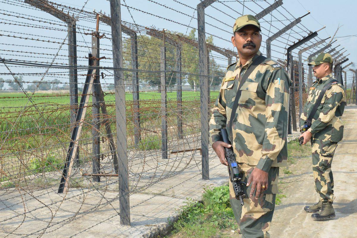 Indian Border Security Force personnel walk along a fence at the India Pakistan border on the outskirts of Amritsar on Feb. 27, 2019. (NARINDER NANU/AFP/Getty Images)