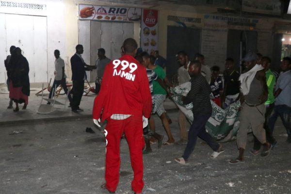 Volunteers and rescue workers evacuate an injured victim outside the Maka Al-Mukarama hotel in the Somalia capital, Mogadishu, on Feb. 28, 2019, after a car bomb exploded, killing at least five people and wounding 25 others. (Abdirazak Hussein Farah/AFP/Getty Images)