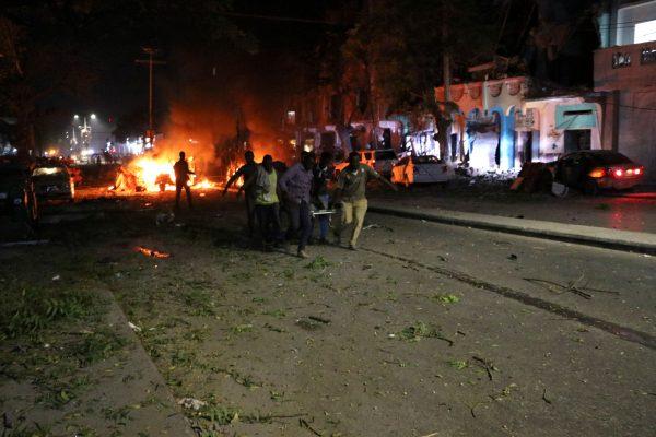 Rescuers run as they carry a stretcher in Mogadishu, the capital of Somalia, on Feb. 28, 2019, after a car bomb exploded close to a major hotel, killing at least 10 people and wounding 25 others. (Abdirazak Hussein Farah/AFP/Getty Images)