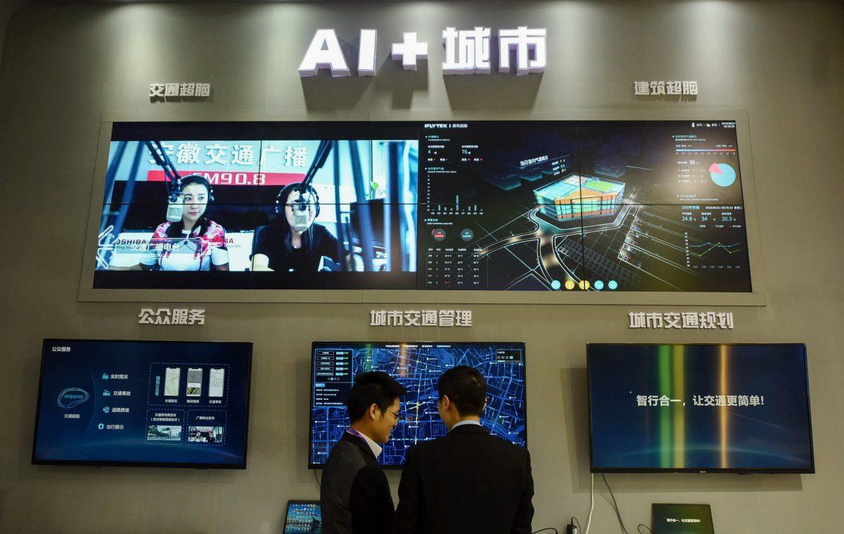 Visitors look at an AI smart city system by iFLY at the 2018 International Intelligent Transportation Industry Expo in Hangzhou, Zhejiang Province, China, in December 2018. (STR/AFP/Getty Images)