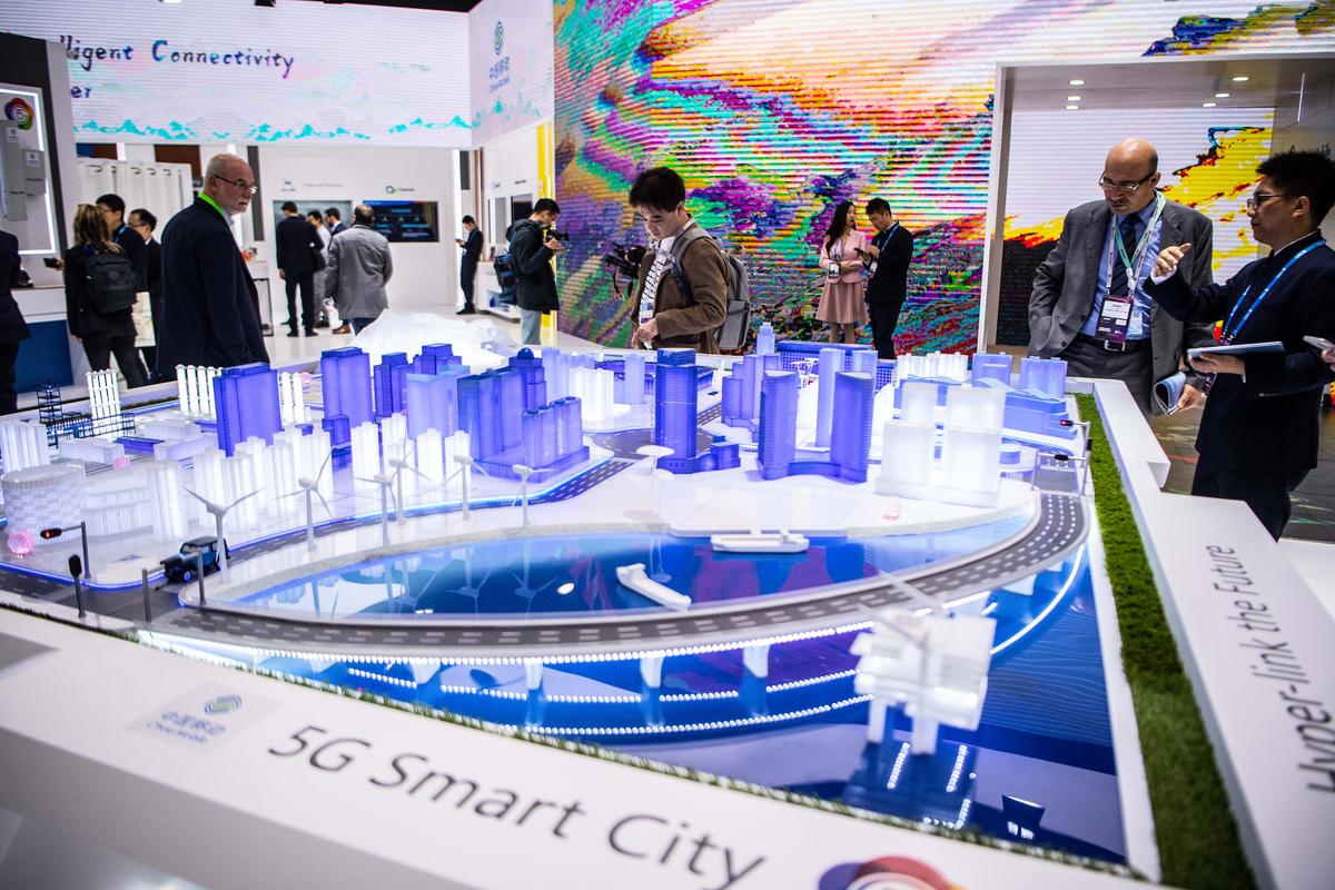 Visitors check 5G Smart City technology at the China Mobile booth at the GSMA Mobile World Congress 2019 in Barcelona, Spain, on Feb. 26, 2019. The annual Mobile World Congress hosts some of the world's largest communications companies. (David Ramos/Getty Images)