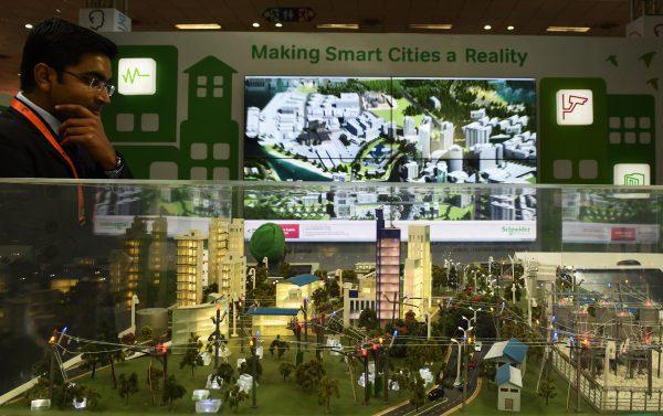 A visitor looks at a model of a 'smart city' at the Smartcity Expo in New Delhi, India on May 20, 2015. The expo is showcasing sustainable living and environmental projects. (Sajjad Hussain/AFP/Getty Images)
