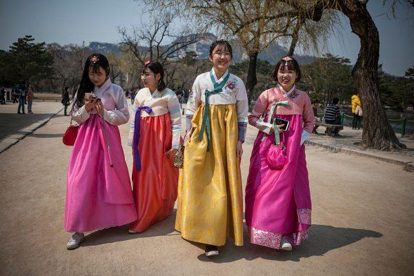 Young Koreans wearing hanbok (Korean traditional dress) walk inside Gyeongbok Palace on March 27, 2016 in Seoul, South Korea. There has been a trend in recent years for the young Koreans to wear the traditional Korean dress, Hanbok. Wearing the traditional dress, they will walk around downtown Seoul on weekends taking selfies, and share their memories with friends on social media, and also to promote their traditional dress to foreign visitors. (©Getty Images | <a href="https://www.gettyimages.com/detail/news-photo/young-koreans-wearing-hanbok-walk-inside-gyeongbok-palace-news-photo/517754270">Jean Chung</a>)