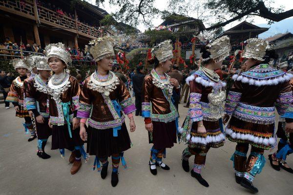 Miao Minority villagers dance during events around a traditional Chinese New Year horse fighting competition for the Year of the Horse at the village of Tiantou in China's Guangxi Province on Feb. 2, 2014. (©Getty Images | <a href="https://www.gettyimages.com/detail/news-photo/miao-minority-villagers-dance-during-events-around-a-news-photo/466541985">Mark Ralston/AFP</a>)