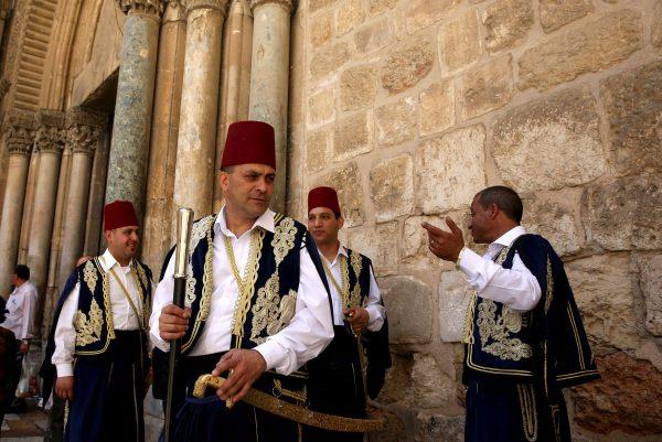 Kawases of the Greek Orthodox patriarchate in traditional Ottoman outfits stand outside the church of the Holy Sepulchre in Jerusalem's Old City during the Orthodox Christian Easter procession marking the resurrection of Jesus, on May 1, 2016. (©Getty Images | <a href="https://www.gettyimages.com/detail/news-photo/kawases-of-the-greek-orthodox-patriarchate-in-traditional-news-photo/526798032">Gali Tibbon/AFP</a>)