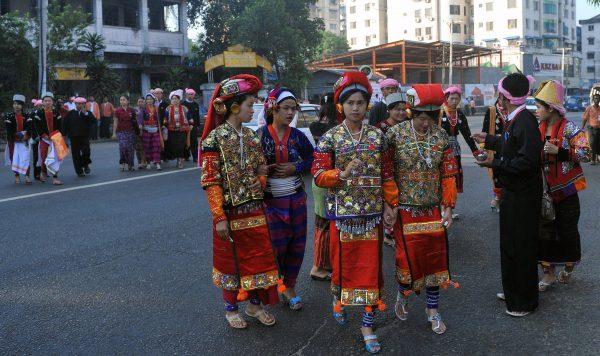 Ethnic Palaung women wear traditional dress as they wait for the arrival of National League for Democracy (NLD) delegates during the NLD's first-ever party conference at the Royal Rose Hall in Rangoon on March 9, 2013. (©Getty Images | <a href="https://www.gettyimages.com/detail/news-photo/ethnic-palaung-woman-wears-traditional-dress-as-they-wait-news-photo/163384890">Ye Aung Thu/AFP</a>)