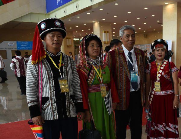 Peace conference delegate Ah Moe Si (L) with other Lisu ethnic group members from upper Kachin State, wearing a round black hat studded with circular patterns of white, blue, and red beads of the Lisu people—as a symbol of solidarity with other minorities—pose for a photo at the convention center in Naypyidaw on Aug. 31, 2016. (©Getty Images | <a href="https://www.gettyimages.com/detail/news-photo/peace-conference-delagate-ah-moe-si-with-other-lisu-ethnic-news-photo/598647148">Romeo Gacad/AFP</a>)
