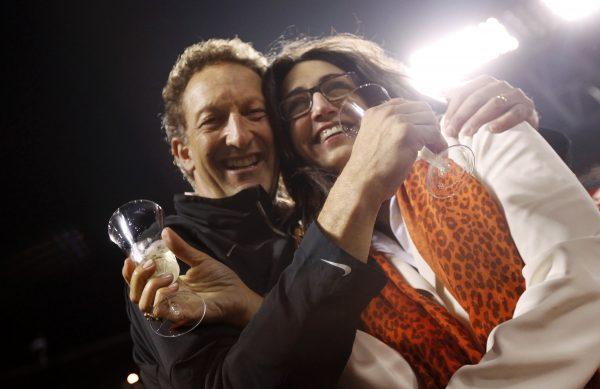 San Francisco Giants President Larry Baer and his wife, Pam, celebrate with champagne after the Giants defeated the San Diego Padres during their MLB baseball game to win the National League West Division title in San Francisco, Calif., on Sept. 22, 2012. (Robert Galbraith/Reuters)