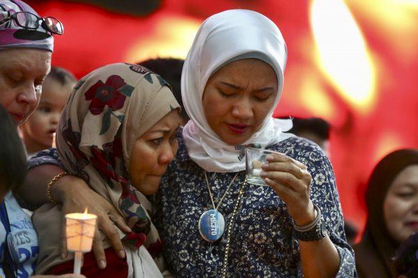 Norazlinda Ayub, left, and Intan Maizura Othaman, wife of an air crew member of Malaysia Airlines Flight 370, Sunday, March 3, 2019. (AP Photo/Annice Lyn)