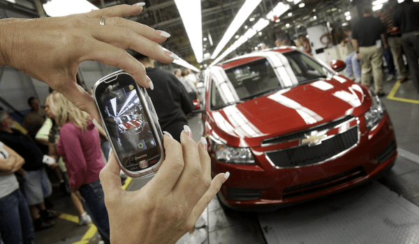 <br/>An auto worker takes a picture of the first Chevrolet Cruze compact sedan to come off the assembly line at a ceremony inside the GM factory in Lordstown, Ohio. On Sept. 8, 2010. (AP Photo/Amy Sancetta)