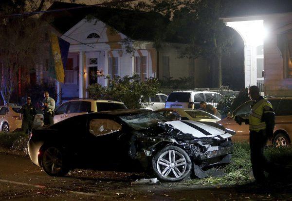 New Orleans Police examine a Chevy Camaro on Esplanade Avenue in New Orleans that struck multiple people, killing several and injuring others, after the Endymion Mardi Gras parade finished passing nearby on March 2, 2019. (Michael DeMocker/NOLA.com/The Times-Picayune via AP)
