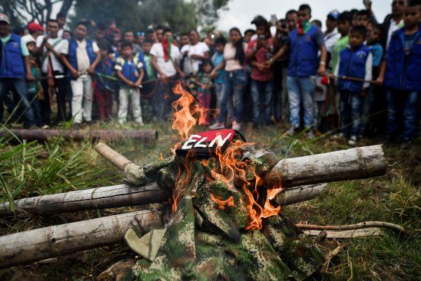 Indigenous people of the Nasa ethnic group burn uniforms seized from ELN guerrillas, on July 6, 2018, in Corinto, Cauca department, Colombia. (Luis Robayo/AFP/Getty Images)