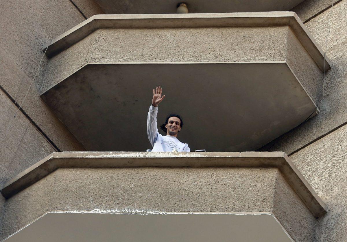 Mahmoud Abu Zaid, waves to his neighbors from his home balcony in Cairo, Egypt, on March 4, 2019. (Amor Nabil/AP Photo)