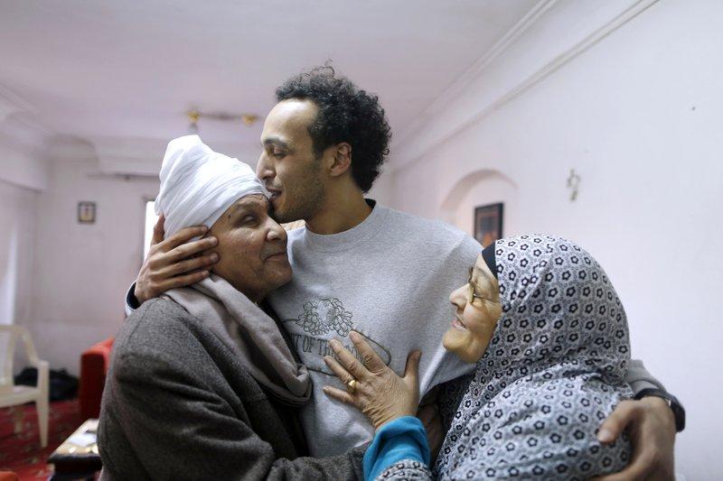 Mahmoud Abu Zaid, a photojournalist known as Shawkan, center, is hugged by his parents at his home in Cairo, Egypt, on March 4, 2019. Shawkan was released after five years in prison. (Amor Nabil/AP Photo)