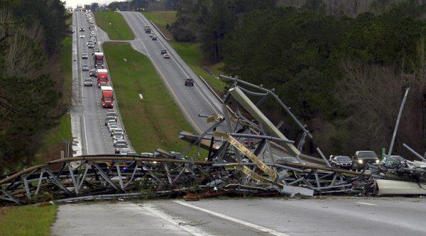 A fallen cell tower lies across U.S. Route 280 highway in Lee County, Ala., in the Smiths Station community after a tornado struck the area on March 3, 2019. (Mike Haskey/Ledger-Enquirer via AP)