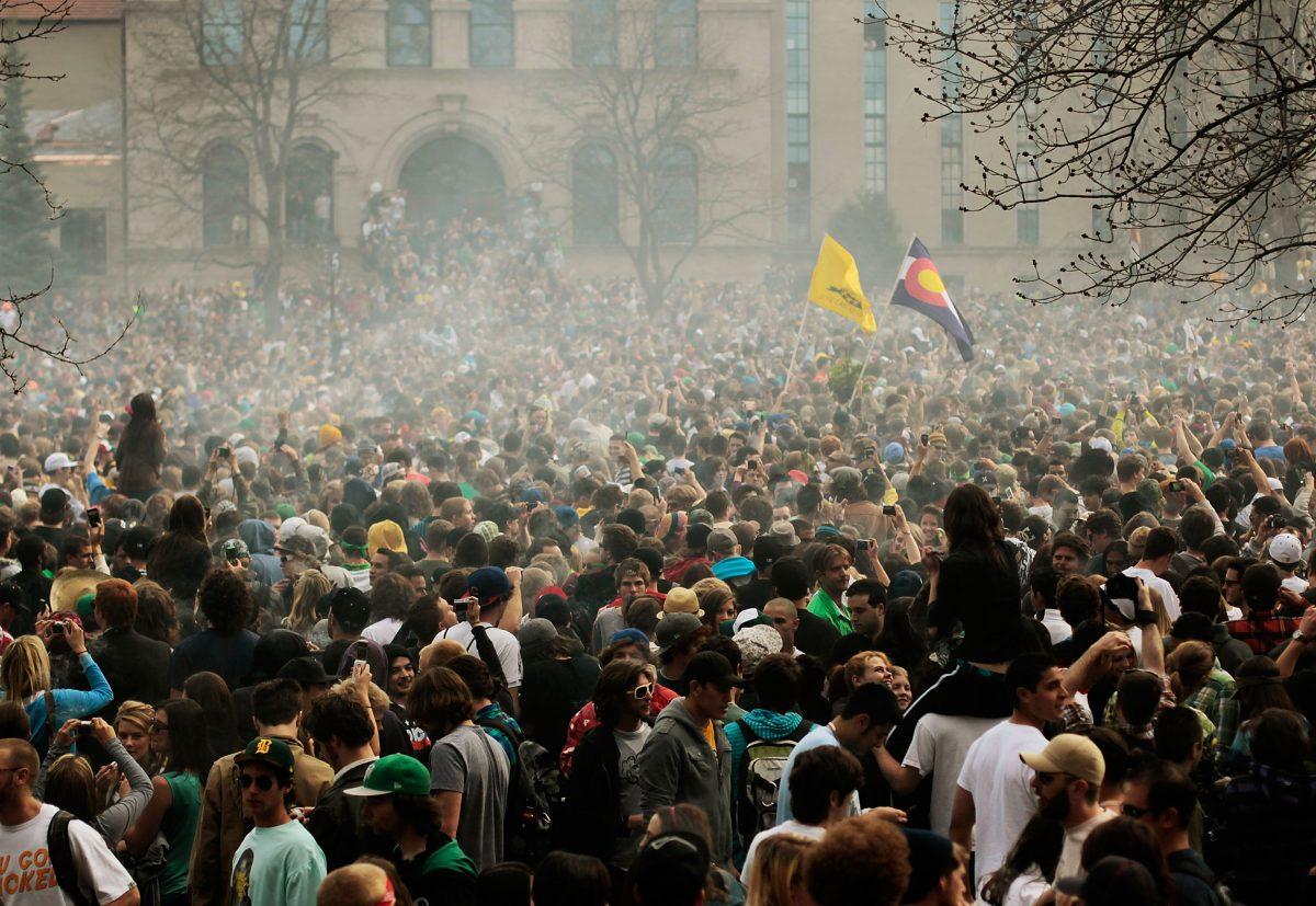 The haze of marijuana smoke looms over a crowd of thousands at the University of Colorado in Boulder, Colo., on April 20, 2010. (Chris Hondros/Getty Images)