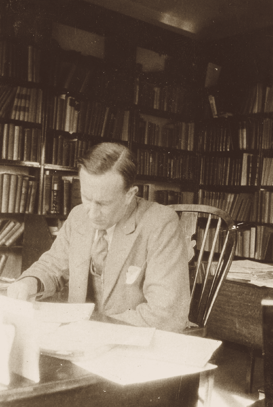 J.R.R. Tolkien in his study, circa 1937. Black and white photograph. Tolkien Trust. (The Tolkien Trust 2015)