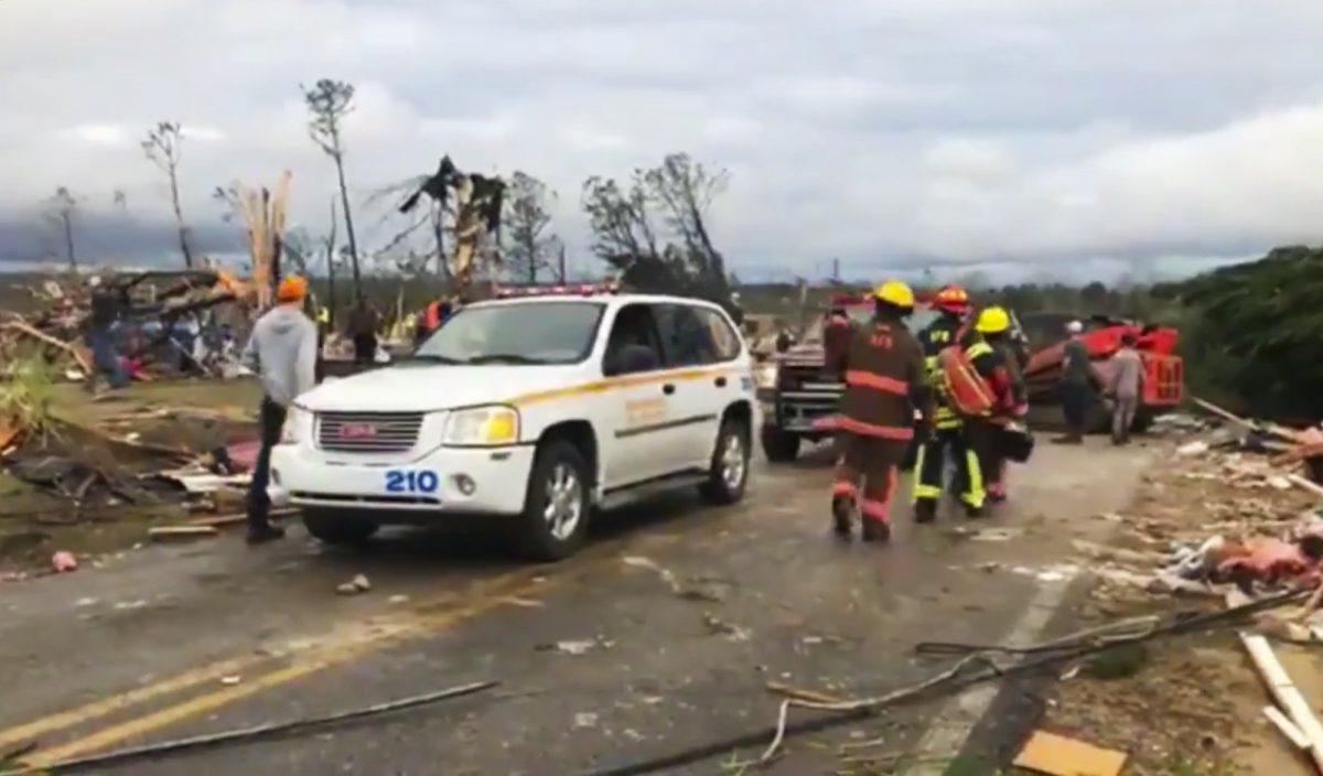 Emergency responders work in the scene amid debris in Lee County, Ala., after a tornado to strike the area on March 3, 2019. Severe storms destroyed mobile homes, snapped trees and left a trail of destruction amid weather warnings extending into Georgia, Fla. and S.C., authorities said. (WKRG-TV via AP)