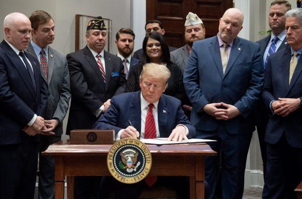 President Donald Trump signs an executive order to help reduce veteran suicides at the White House in Washington on March 5, 2019. (SAUL LOEB/AFP/Getty Images)
