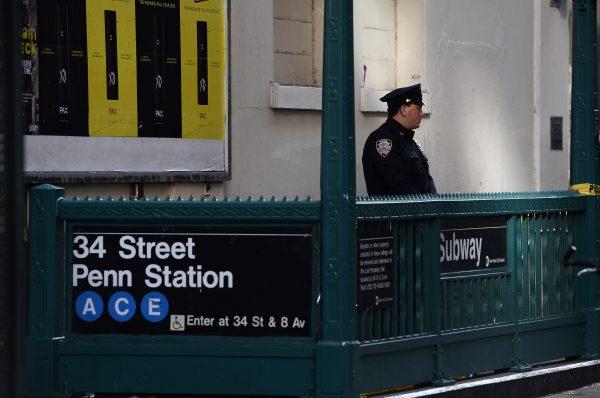 A New York Police Department officer securing the entrance of the 34 St. Penn Station subway in New York City in a file photo. (Jewel Samad/AFP/Getty Images)