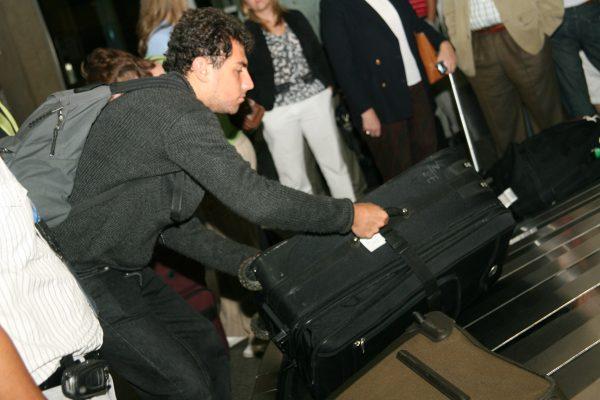 Roy Abdo retrieving his luggage at the airport in Kansas City, Missouri. (Courtesy of Roy Abdo)