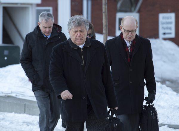Dennis Oland, left, follows his lawyer Alan Gold and Oland family lawyer, Bill Teed, right, as he heads to the Law Courts to continue his testimony in Saint John, N.B., on March 7, 2019. (Andrew Vaughan/The Canadian Press)