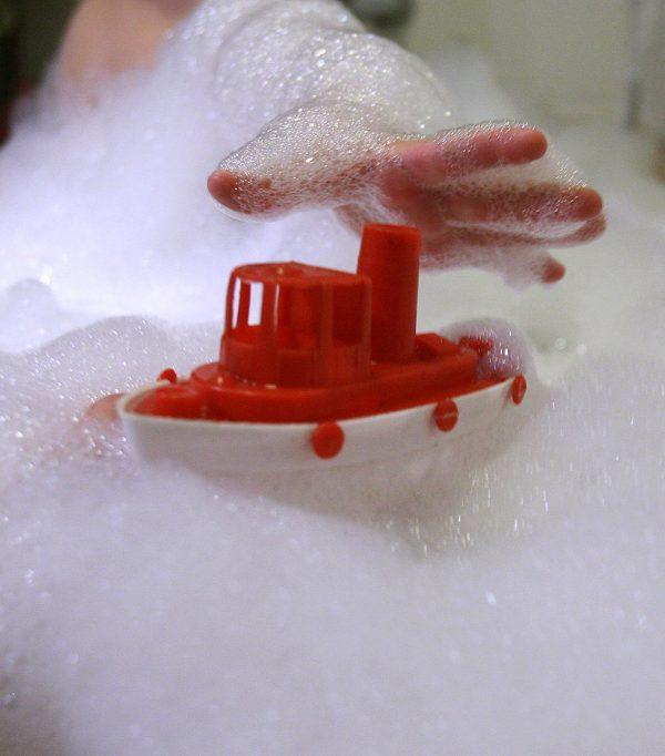 A child in a bubble bath reaches for a plastic toy on Jan. 13, 2007, in Hamburg, Germany. (Alexander Hassenstein/Getty Images)