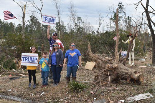 People cheer as the motorcade of President Donald Trump passes during a tour of tornado-affected areas in Beauregard, Alabama, on March 8, 2019. (Nicholas Kamm/AFP/Getty Images)